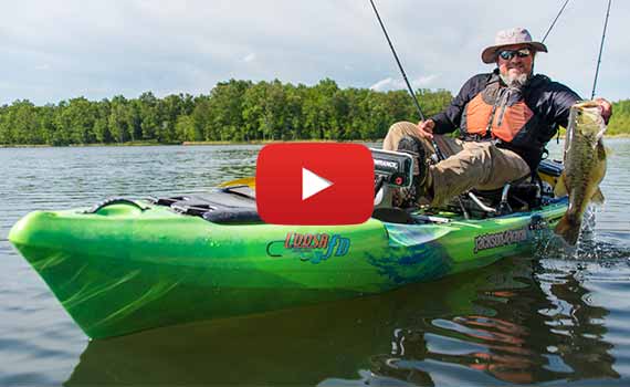 happy angler in a coosa fd kayak with a large largemouth bass