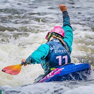 kayaker with arm raised in victory