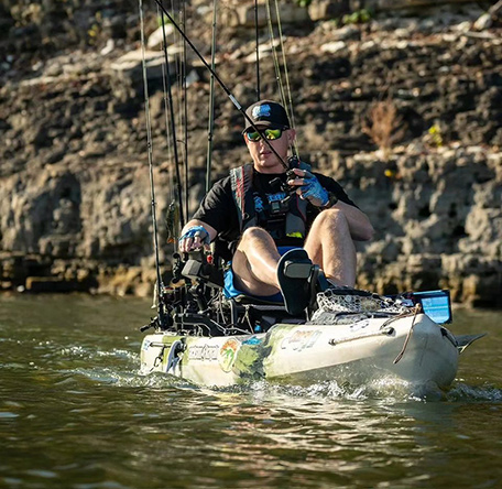 angler with fishing rods loaded down pedaling a big rig fd pedal jackson kayak