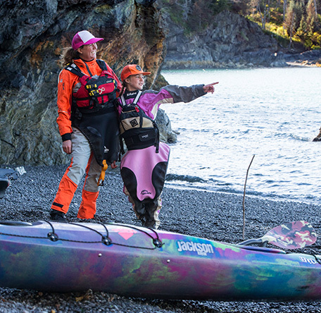 mother and daugher standing beside jackson kayak journeys pointing at things on a beautiful lake