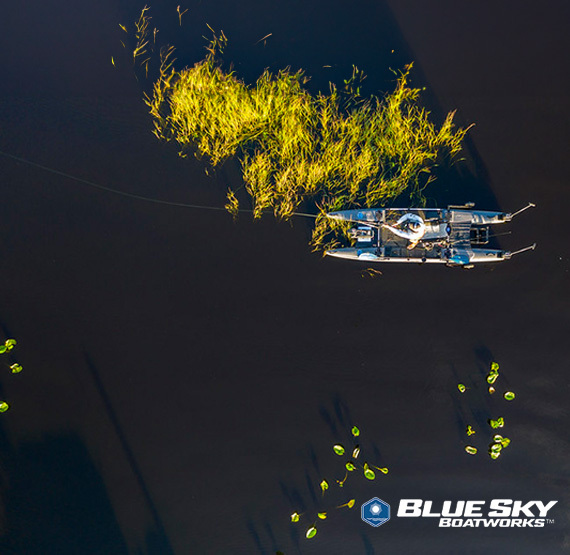 man fishing in grassy flats from a blue sky boatworks 360 angler