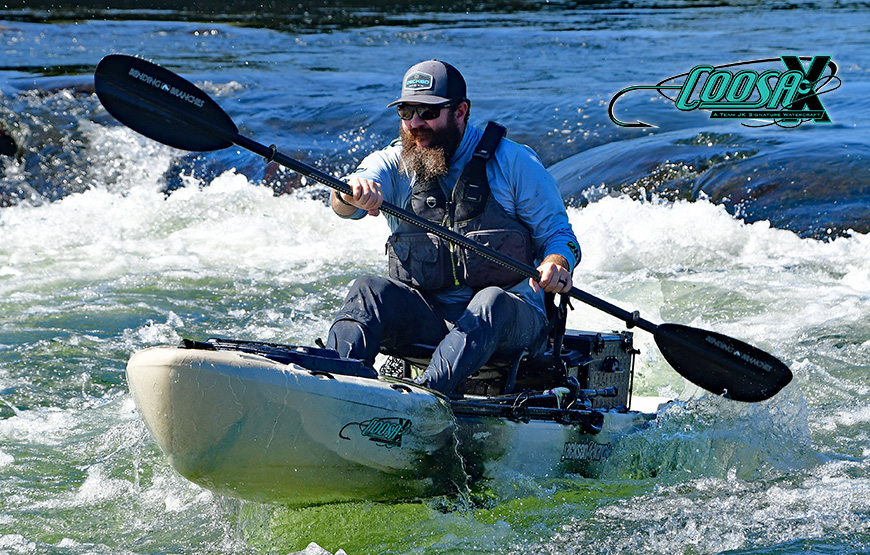 man paddling into whitewater and fishing from a Jackson Kayak Coosa X