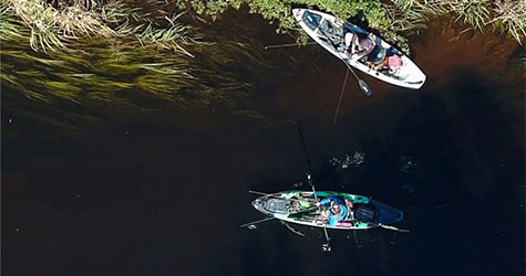 People kayaking in marsh for mobile screens.
