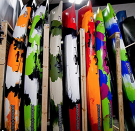 fishing kayaks lined up at a dealer