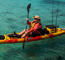 Person kayaking in ocean.