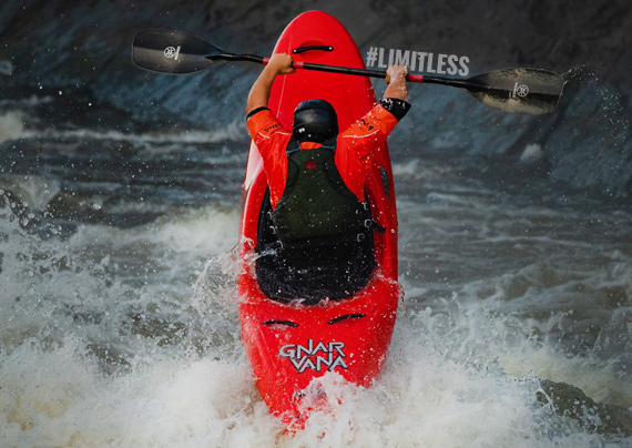 Person kayaking in a whitewater kayak.