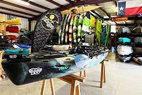 Kayaks to be sold on a shop's floor.