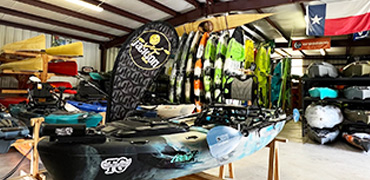 Kayaks to be sold on a shop's floor.