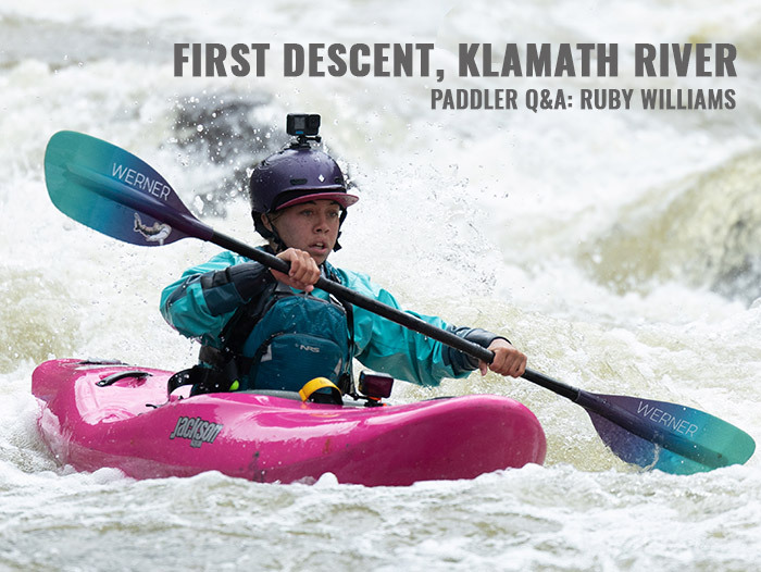 Ruby Williams paddling hard in whitewater in her Jackson Kayak