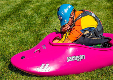 a paddler blows up their floatation accessory