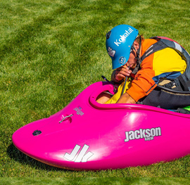 a paddler blows up their floatation accessory