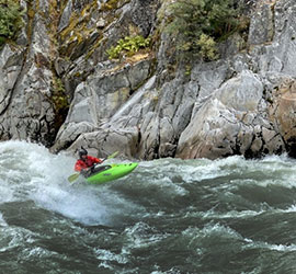 Picture of a person kayaking in whitewater.