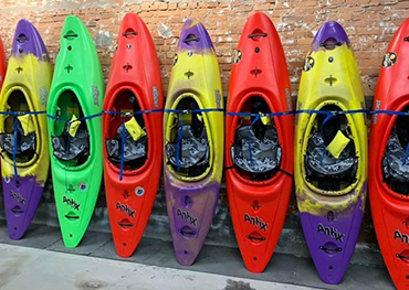 A bunch of kayaks on stands for mobile.